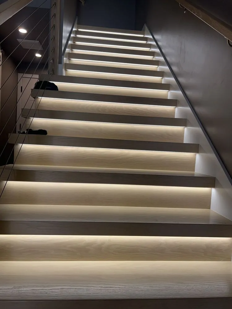 Staircase with an LED light strip glowing under every tread.